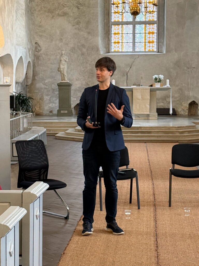 Moderaator seisab mikrofoniga kesklöövis