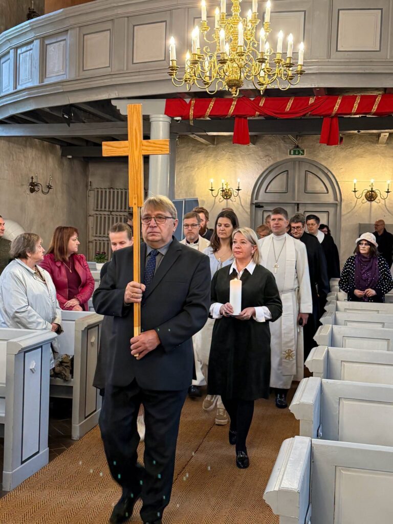 Protsessiooni eesotsas kantakse risti ja küünalt